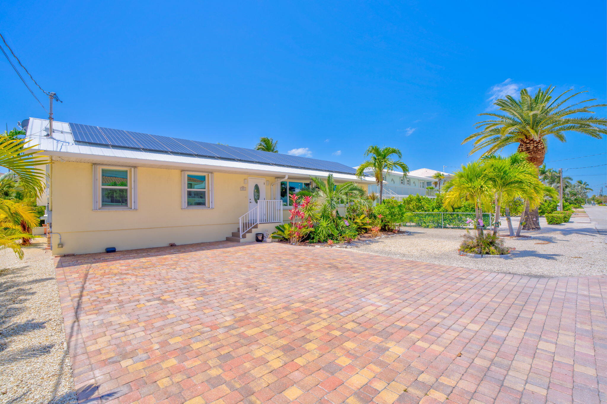 501 11th Street Key Colony Beach, FL 33051 - Photo 7 of 52 a view of a house with a yard and potted plants