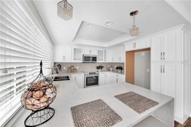a kitchen with stainless steel appliances kitchen island granite countertop a refrigerator and cabinets