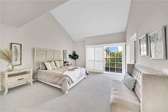 a spacious bedroom with a bed and a large window