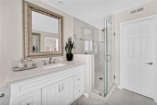 a bathroom with a granite countertop sink mirror and double