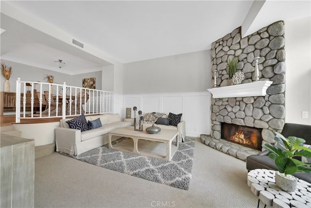 a living room with furniture a fireplace and a fireplace