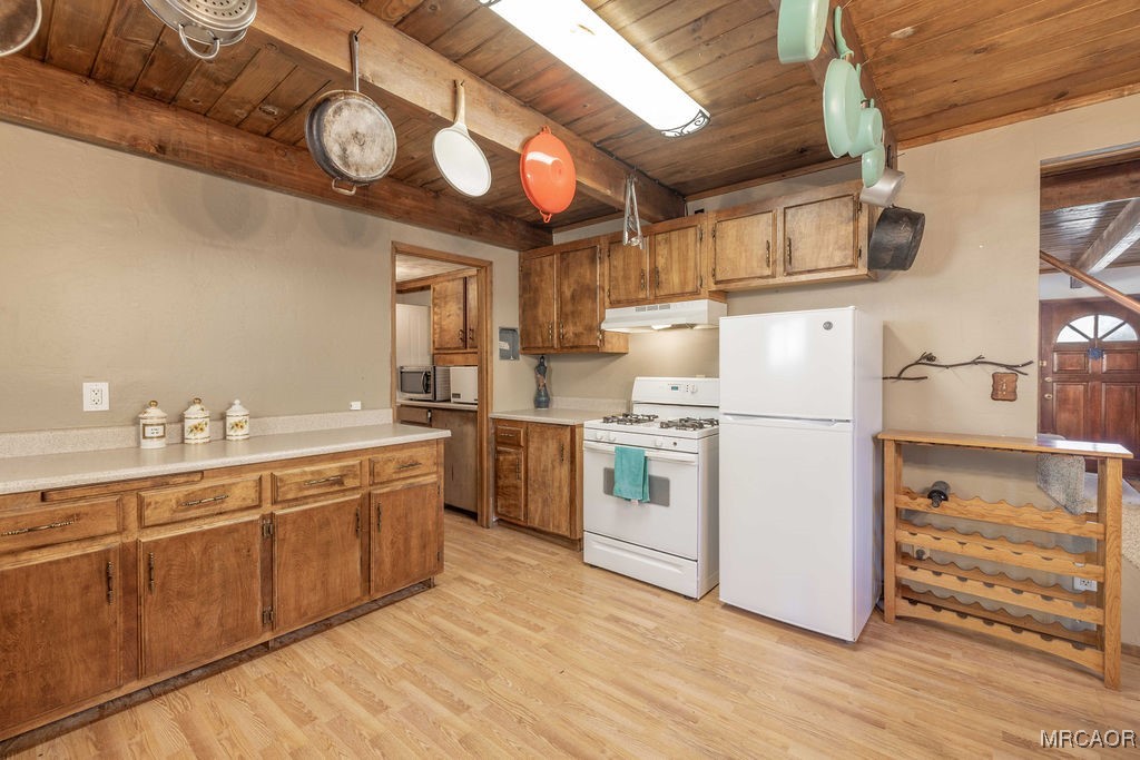 44185 Tim Ron Sugarloaf, CA 92386 - Photo 11 of 45 a kitchen with cabinets a sink and wooden floor