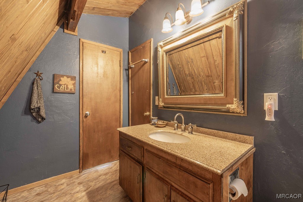 44185 Tim Ron Sugarloaf, CA 92386 - Photo 19 of 45 a bathroom with a sink vanity and a mirror