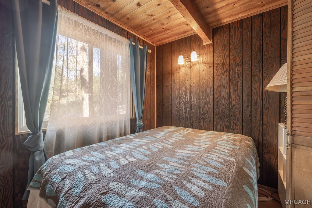 44185 Tim Ron Sugarloaf, CA 92386 - Photo 25 of 45 a bed sitting in a bedroom next to a window