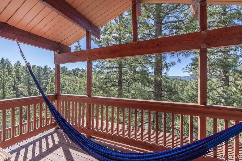 44185 Tim Ron Sugarloaf, CA 92386 - Photo 3 of 45 a view of roof deck with wooden floor and outdoor seating