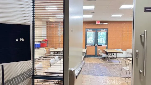 a balcony with chairs and view of living room