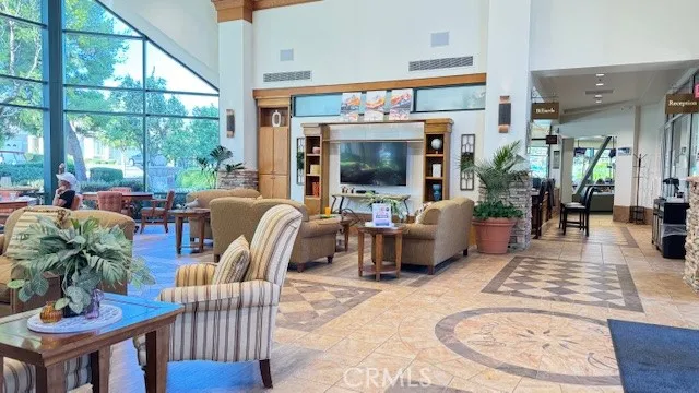 a living room with furniture a large window and a flat screen tv