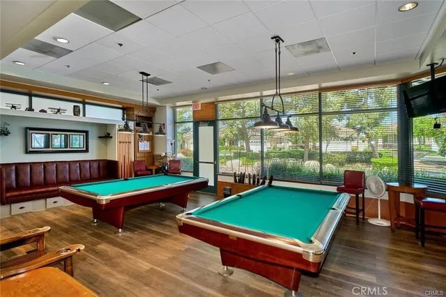 a room with pool table and windows