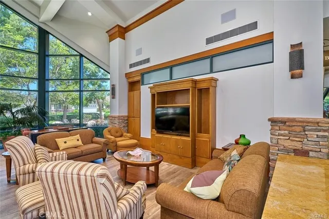 a living room with furniture and a floor to ceiling window