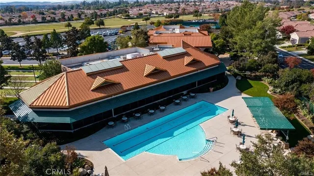 an aerial view of a house with a garden and lake view