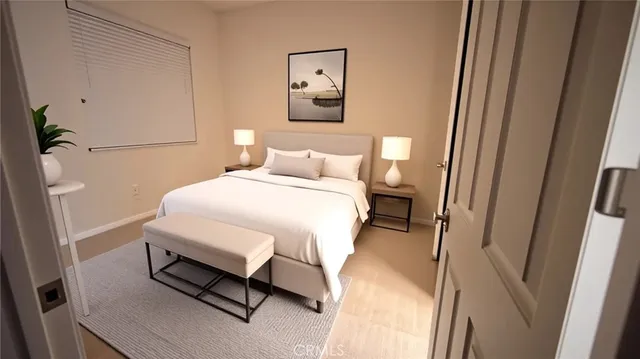 a bedroom with a bed and a white wall
