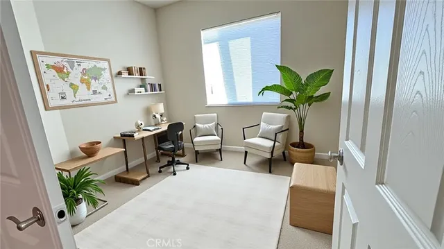 a living room with furniture flowerpot and wooden floor