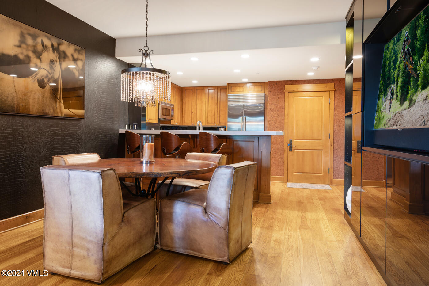1087 Bachelor Ridge Road, Unit 104 Avon, CO 81620 - Photo 13 of 36 a view of a dining room with furniture a chandelier and wooden floor