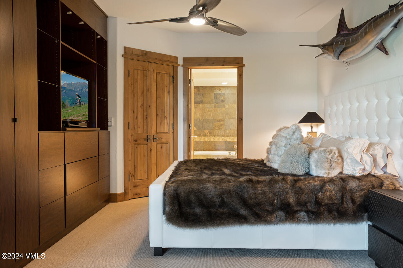 1087 Bachelor Ridge Road, Unit 104 Avon, CO 81620 - Photo 18 of 36 a bedroom with a bed and a large mirror