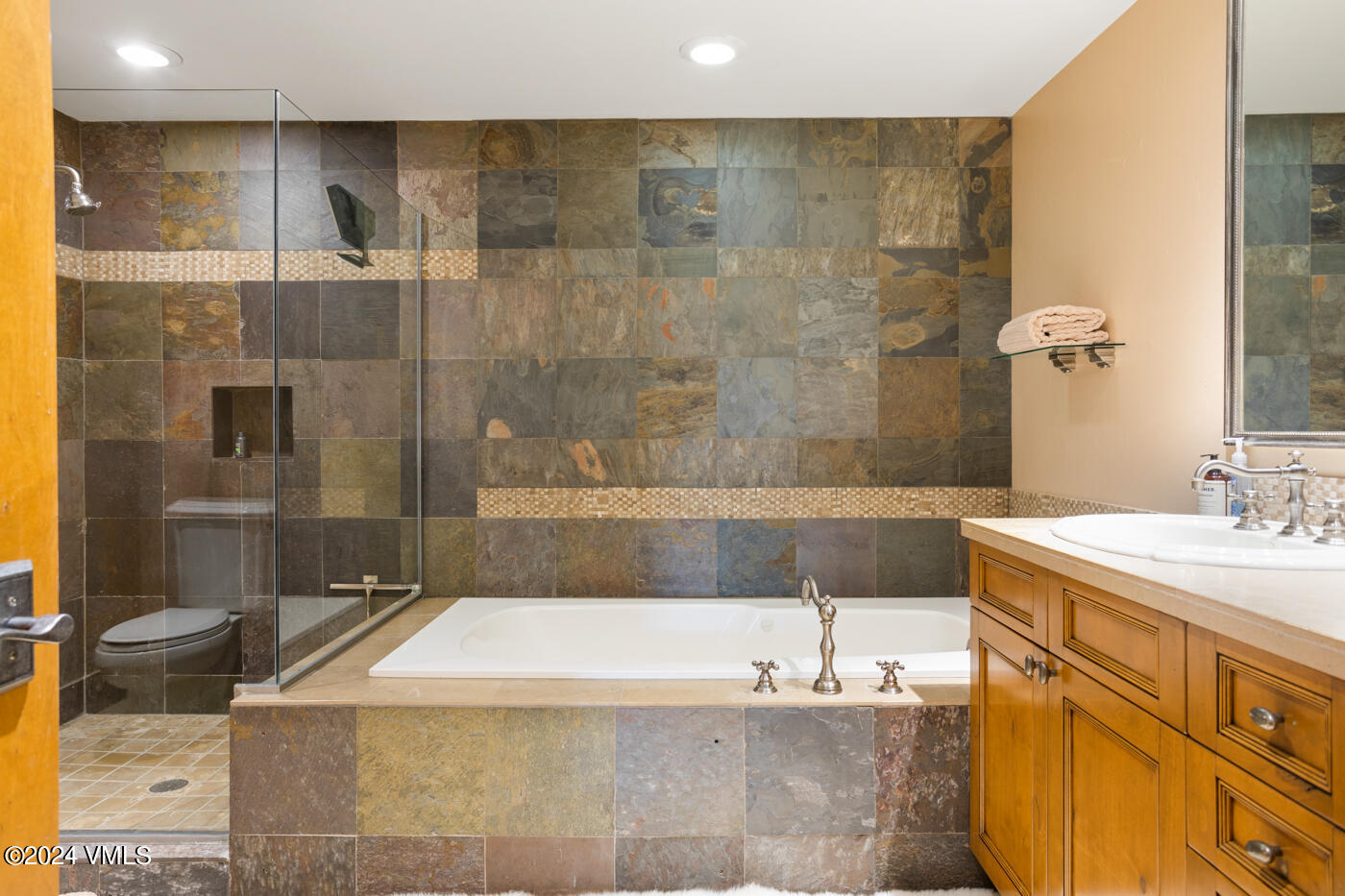 1087 Bachelor Ridge Road, Unit 104 Avon, CO 81620 - Photo 20 of 36 a bathroom with a bathtub and a sink