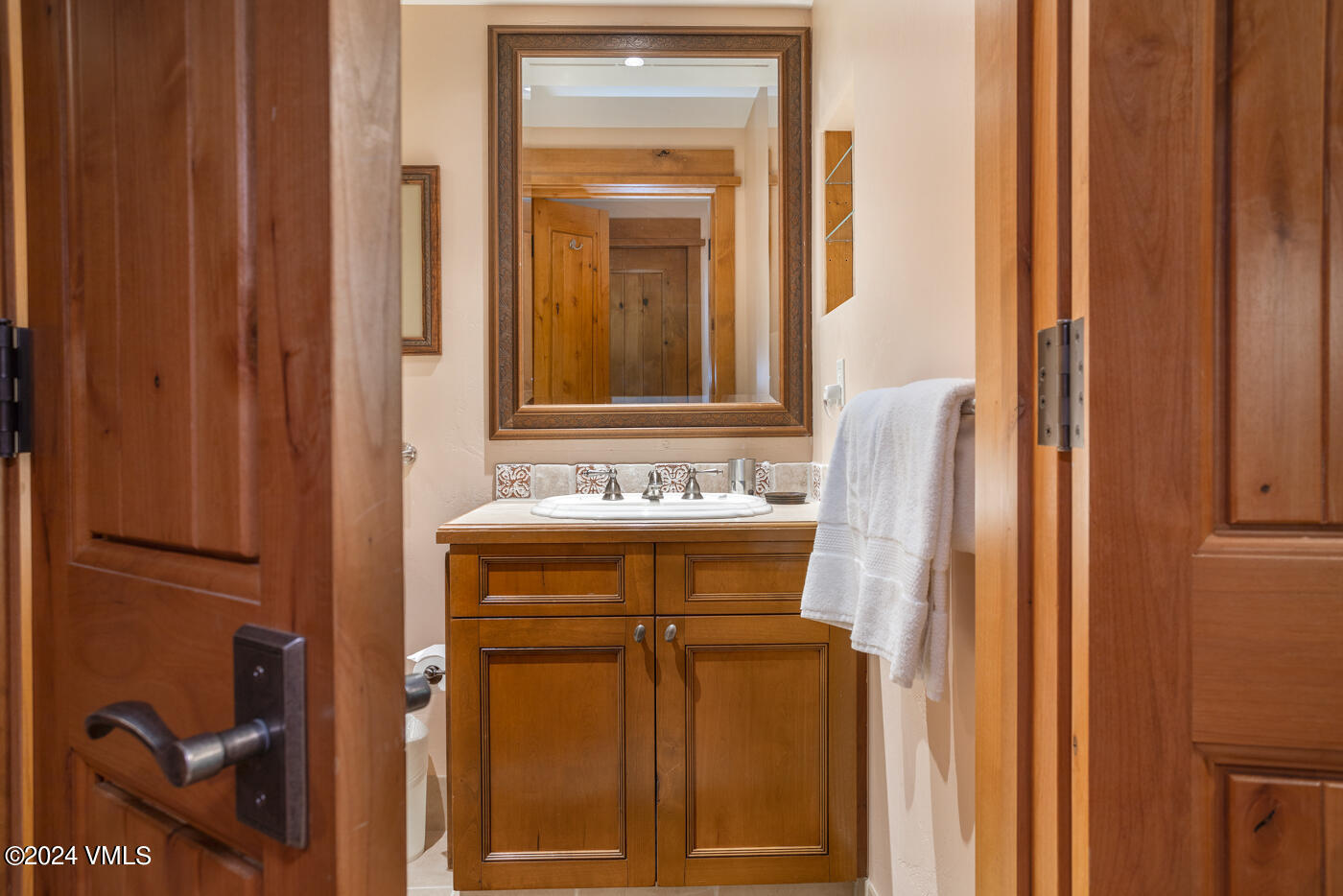1087 Bachelor Ridge Road, Unit 104 Avon, CO 81620 - Photo 26 of 36 a bathroom with a sink and a mirror
