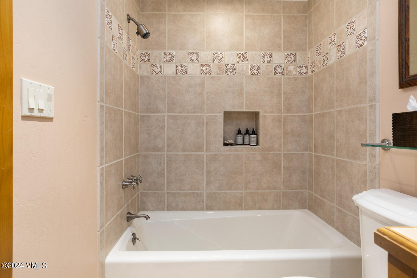 1087 Bachelor Ridge Road, Unit 104 Avon, CO 81620 - Photo 28 of 36 a bath tub sitting next to a white sink and vanity