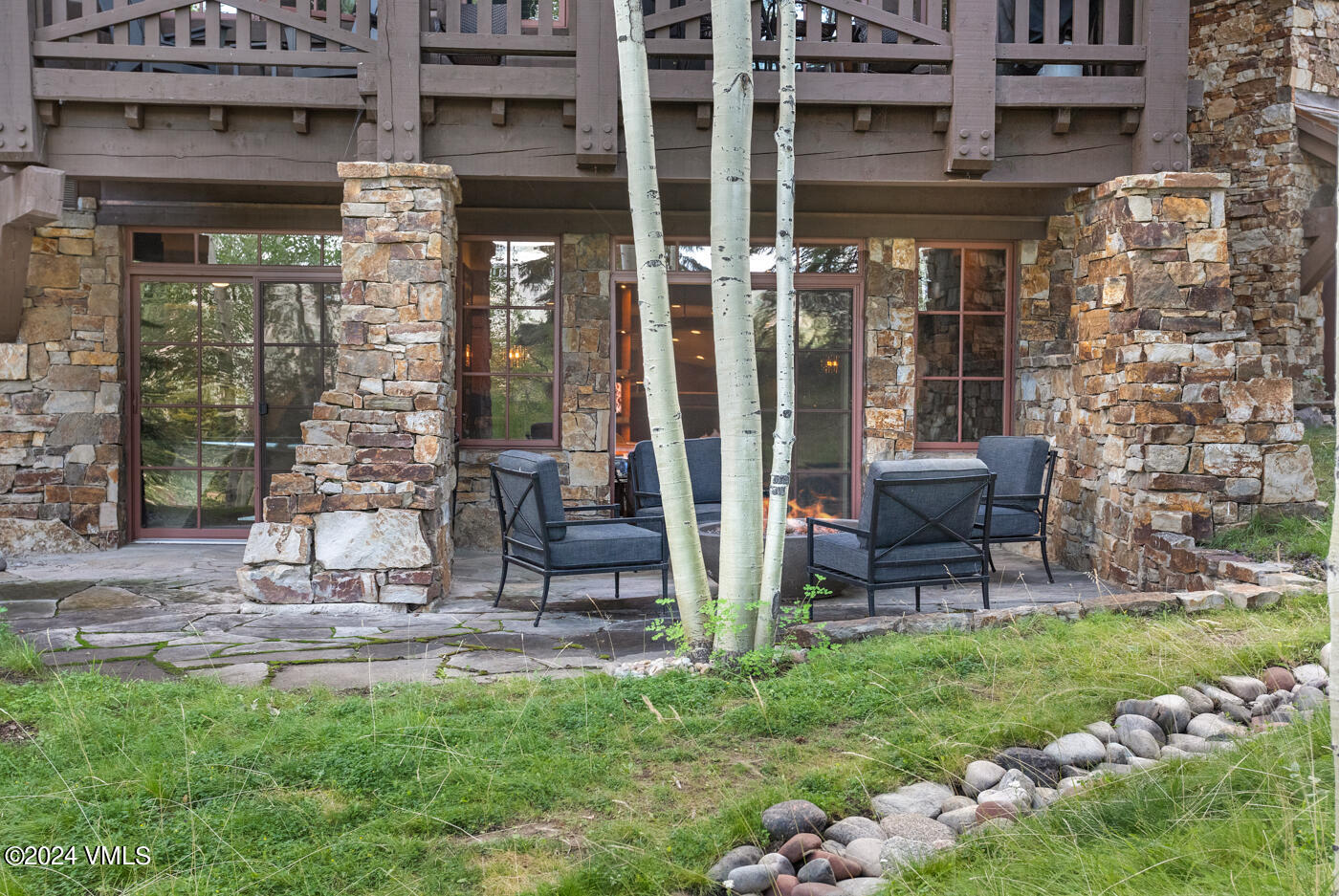 1087 Bachelor Ridge Road, Unit 104 Avon, CO 81620 - Photo 31 of 36 a view of a chairs and a table in a patio