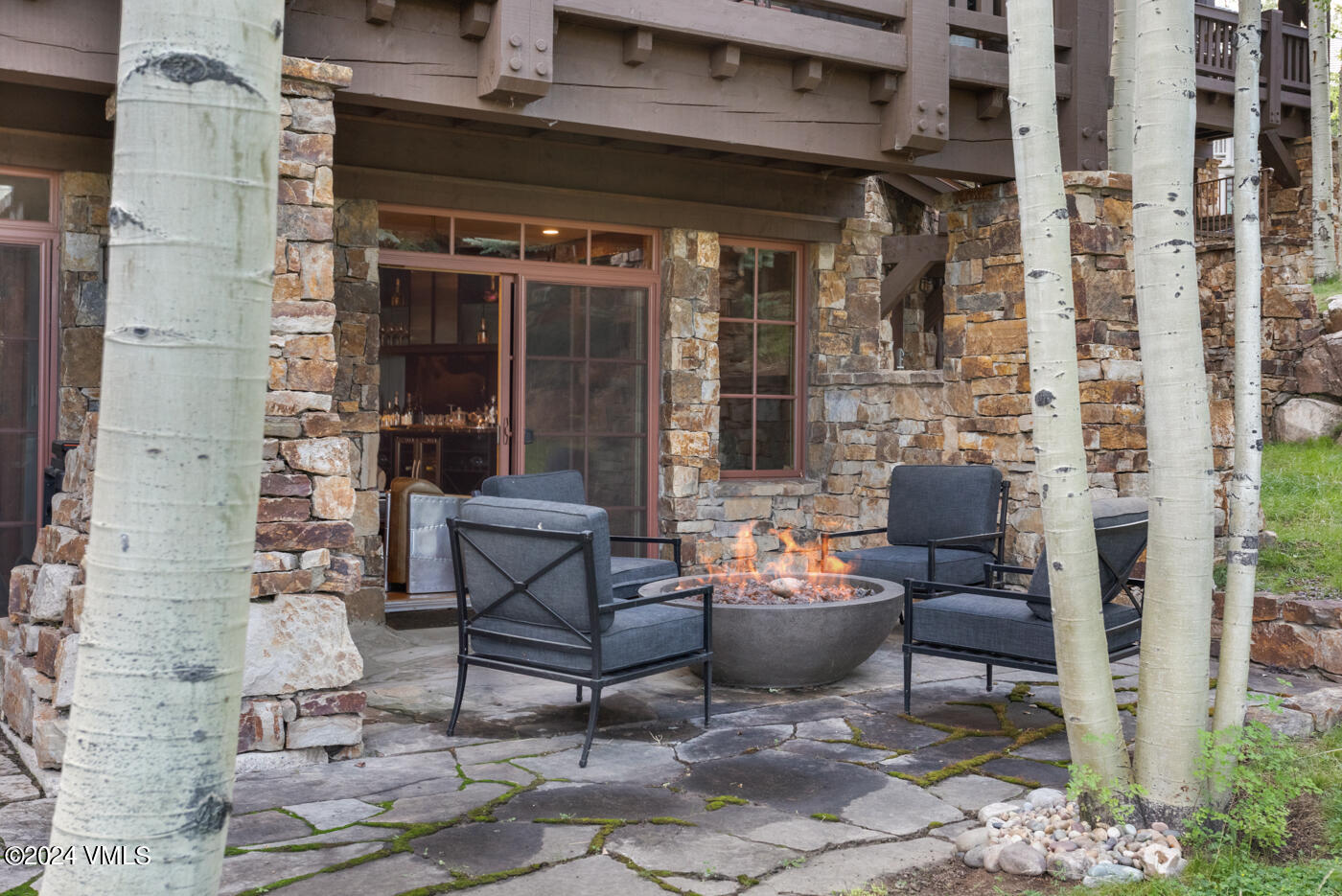 1087 Bachelor Ridge Road, Unit 104 Avon, CO 81620 - Photo 32 of 36 a outdoor living space with patio furniture and a fireplace