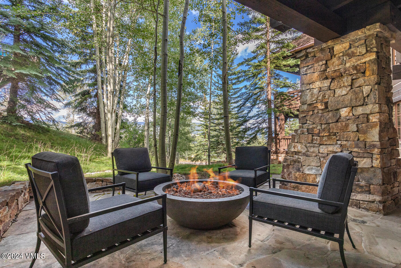 1087 Bachelor Ridge Road, Unit 104 Avon, CO 81620 - Photo 33 of 36 a view of a patio with furniture and a yard