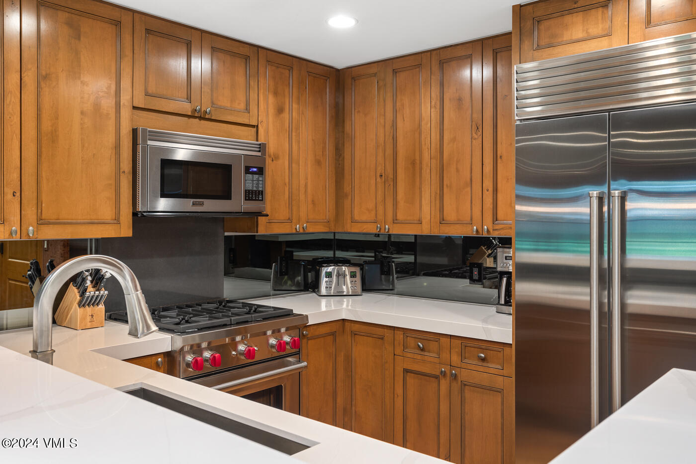 1087 Bachelor Ridge Road, Unit 104 Avon, CO 81620 - Photo 10 of 36 a kitchen with a sink cabinets and stainless steel appliances