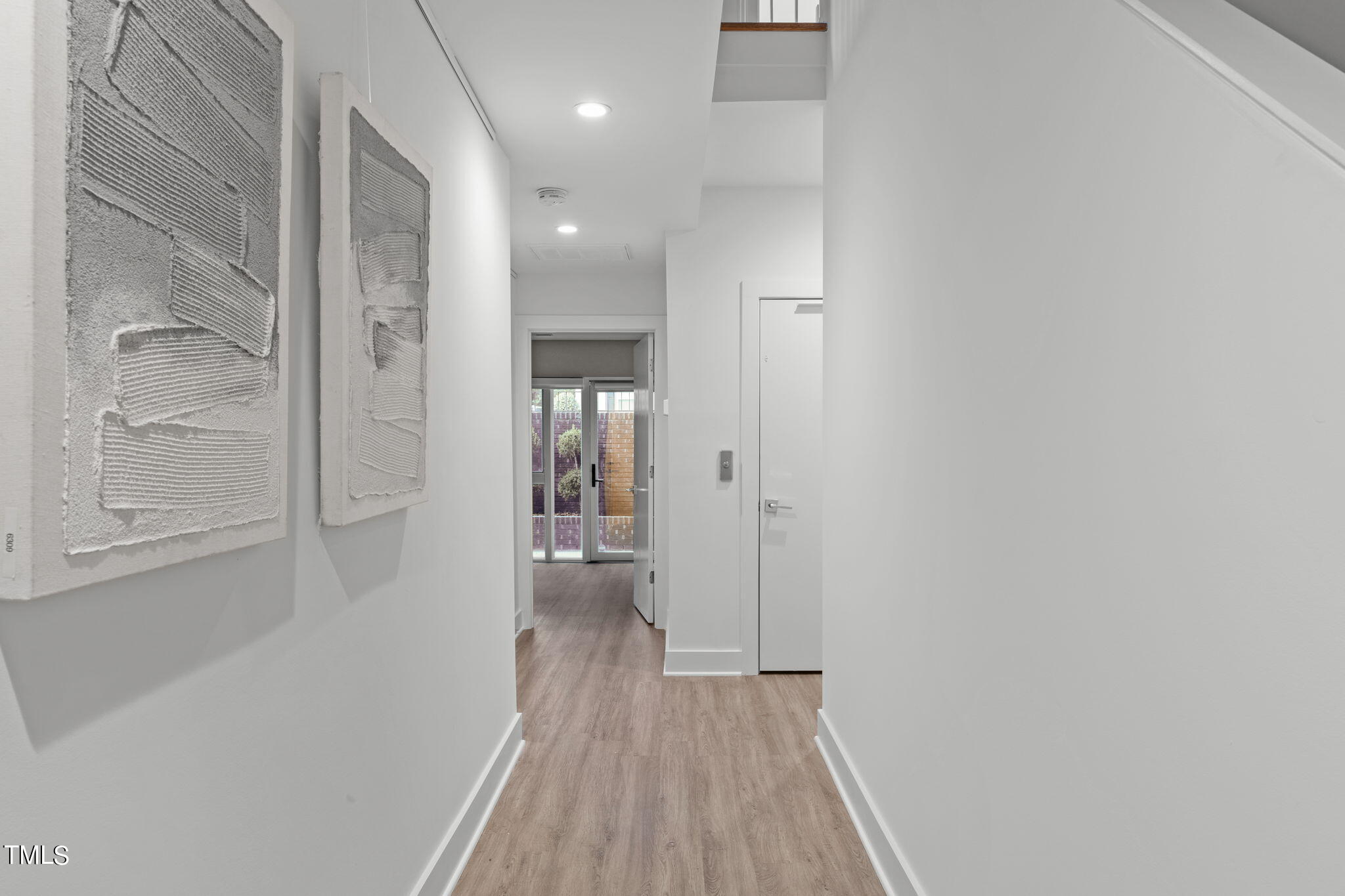 2329 Clark Avenue Raleigh, NC 27607 - Photo 23 of 34 a view of a hallway with wooden floor and a bathroom