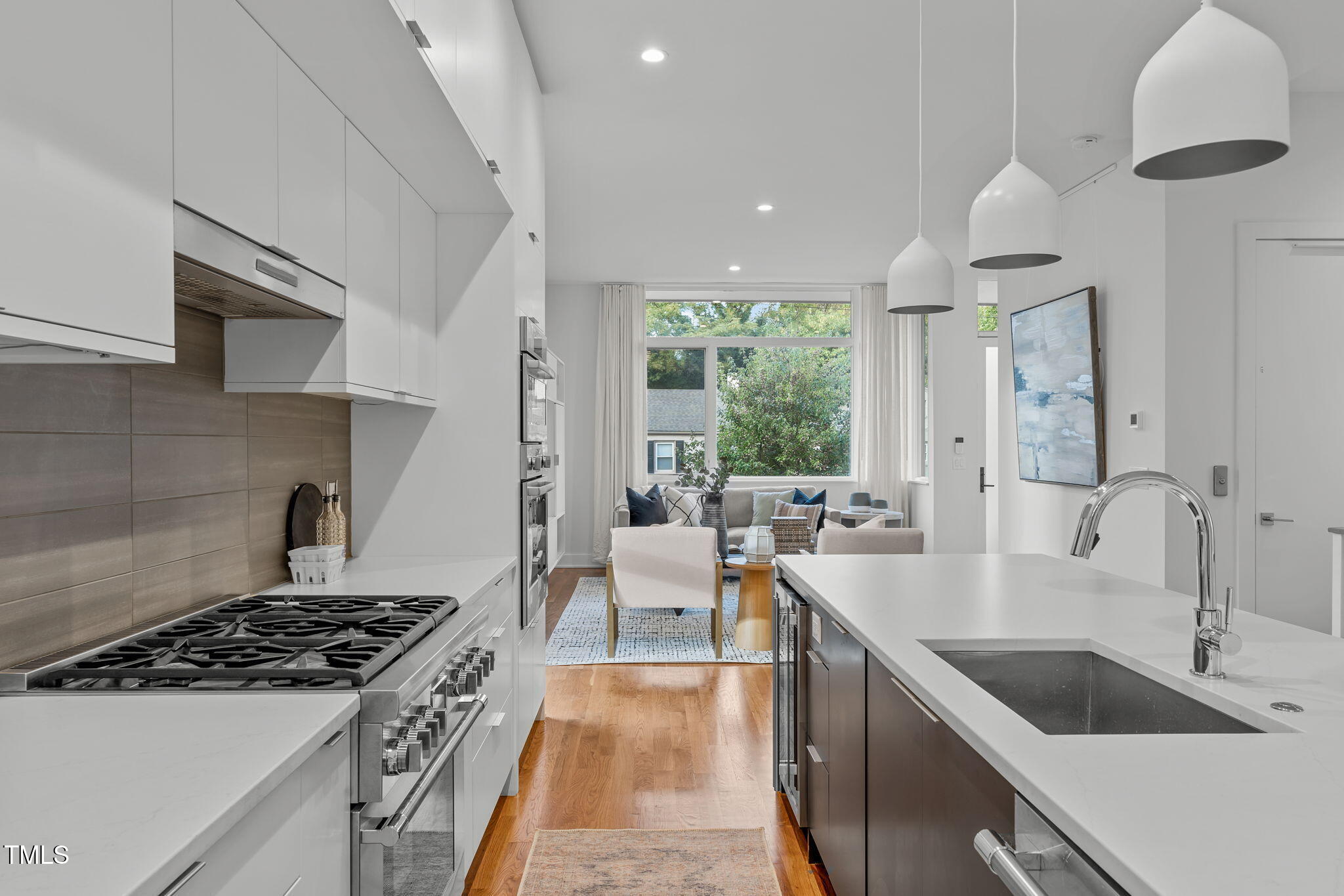2329 Clark Avenue Raleigh, NC 27607 - Photo 8 of 34 a kitchen with counter top space a sink stainless steel appliances and cabinets