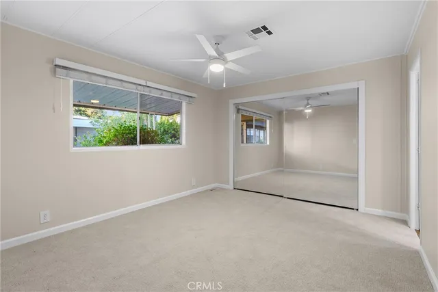 an empty room with a empty space and windows