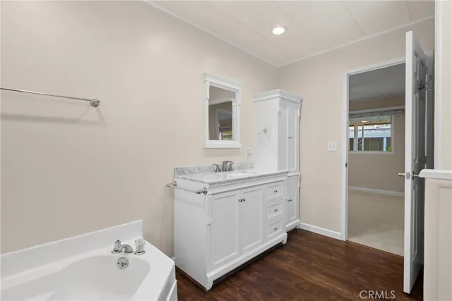 a bathroom with a sink a mirror and a bathtub