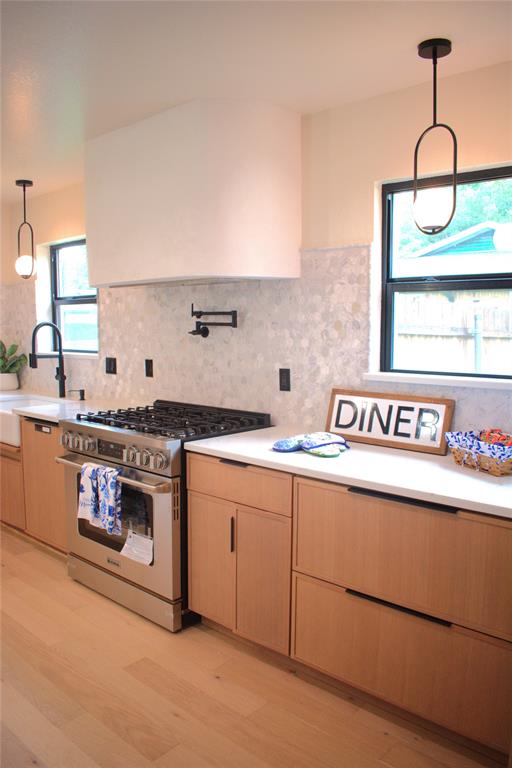 2908 Washington Street Commerce, TX 75428 - Photo 7 of 40 Gourmet kitchen with professional-grade stainless steel range, custom range hood, and light wood-finish cabinetry