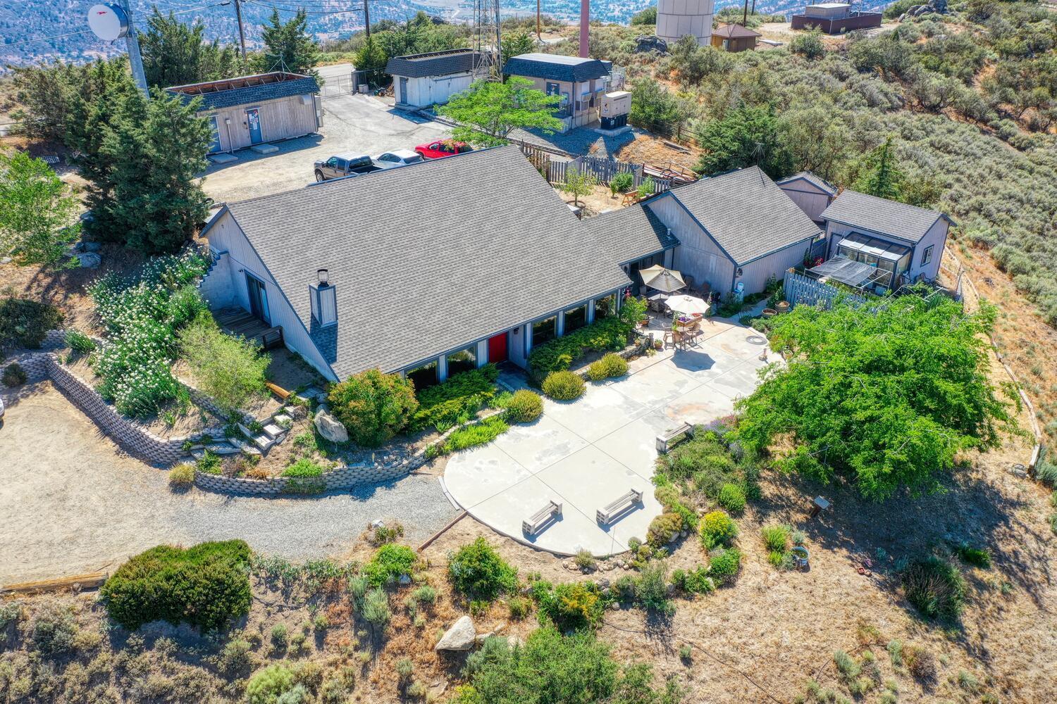 an aerial view of a house with a yard and garden