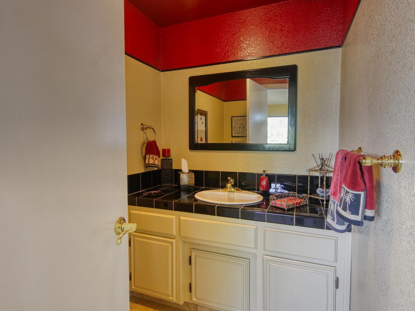 23760 El Rancho Drive Tehachapi, CA 93561 - Photo 20 of 40 a bathroom with a sink and a mirror