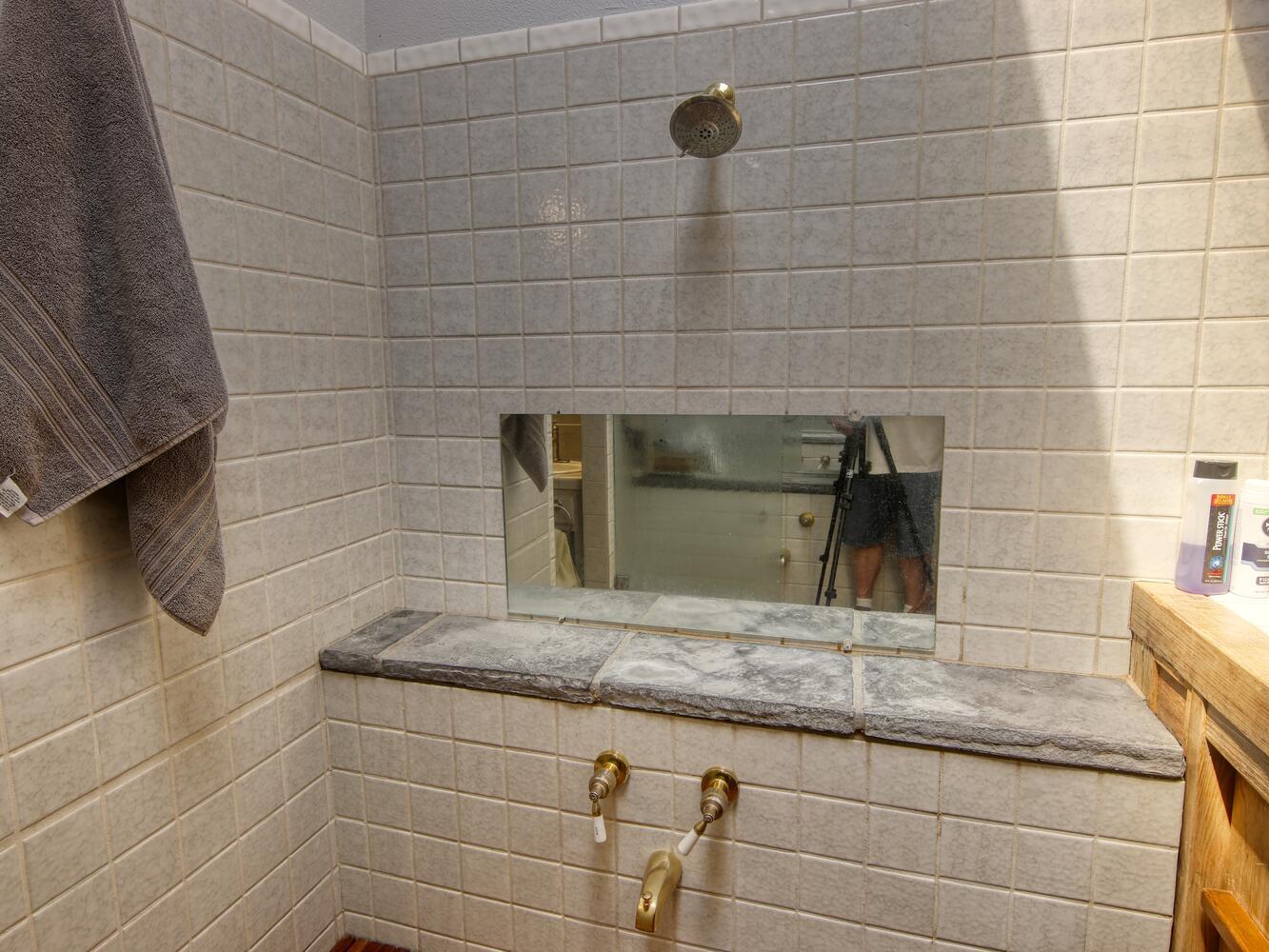 23760 El Rancho Drive Tehachapi, CA 93561 - Photo 23 of 40 a bathroom with a granite countertop sink and a mirror