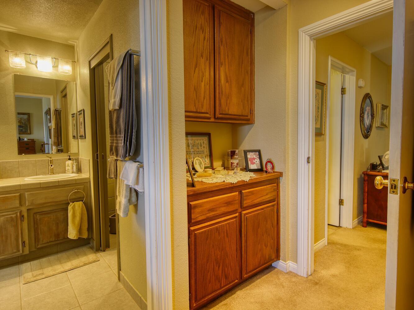 23760 El Rancho Drive Tehachapi, CA 93561 - Photo 25 of 40 a bathroom with a granite countertop sink and a mirror