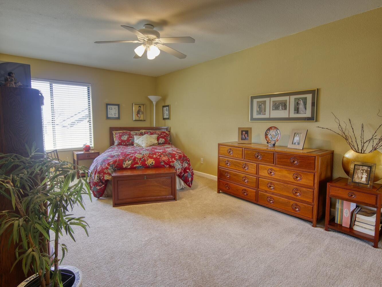 23760 El Rancho Drive Tehachapi, CA 93561 - Photo 28 of 40 a bedroom with a bed and a chandelier