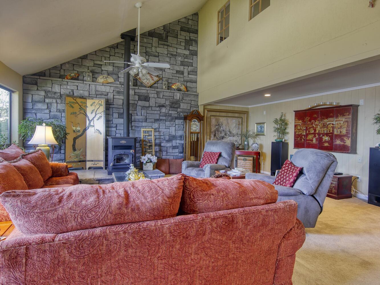 23760 El Rancho Drive Tehachapi, CA 93561 - Photo 6 of 40 a living room with furniture a fireplace and a large window