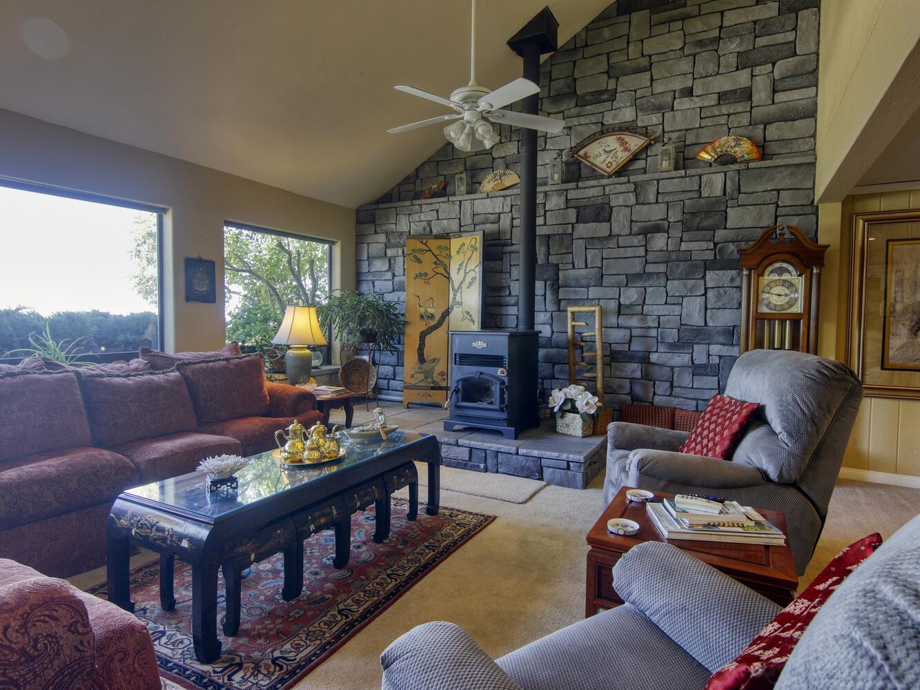 23760 El Rancho Drive Tehachapi, CA 93561 - Photo 7 of 40 a living room with furniture a fireplace and a floor to ceiling window