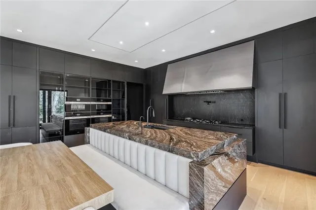 a kitchen with stainless steel appliances kitchen island granite countertop a sink and cabinets