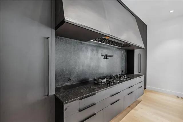 a kitchen with stainless steel appliances granite countertop a refrigerator and a stove