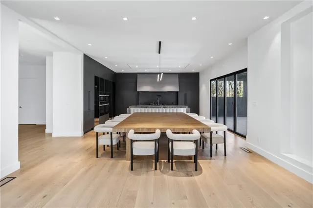 a view of staircase with lots of frames on wall and a large window