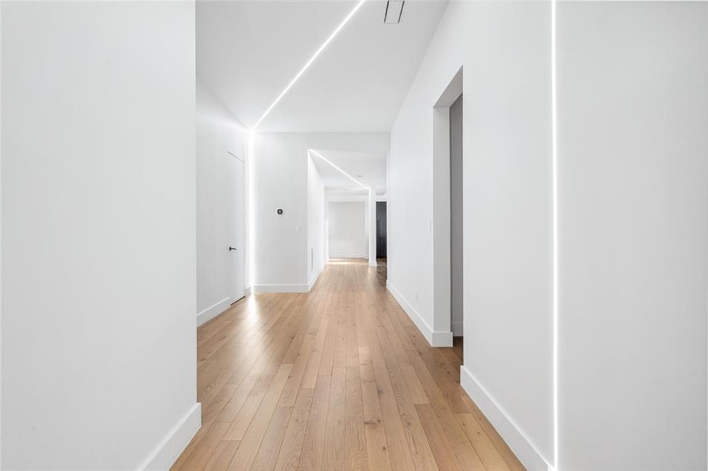 1355 Moores Mill Road Northwest Atlanta, GA 30327 - Photo 20 of 45 a view of a hallway with wooden floor