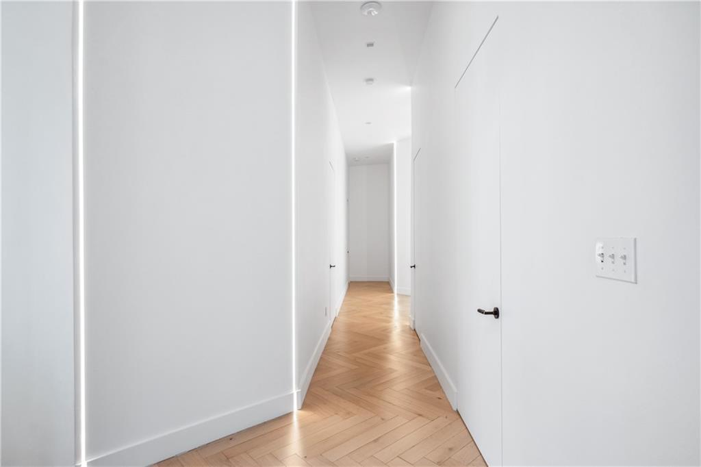1355 Moores Mill Road Northwest Atlanta, GA 30327 - Photo 21 of 45 a view of a hallway with wooden floor