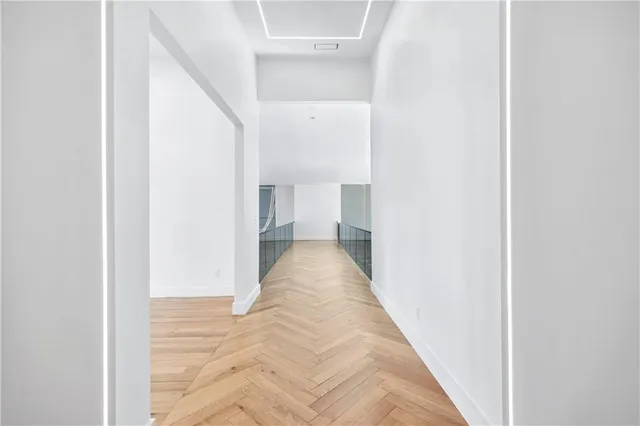 a view of a hallway with wooden floor