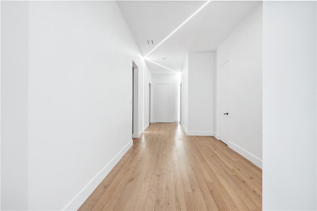 1355 Moores Mill Road Northwest Atlanta, GA 30327 - Photo 23 of 45 a view of a hallway with wooden floor