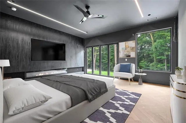 a living room with furniture a flat screen tv and a floor to ceiling window