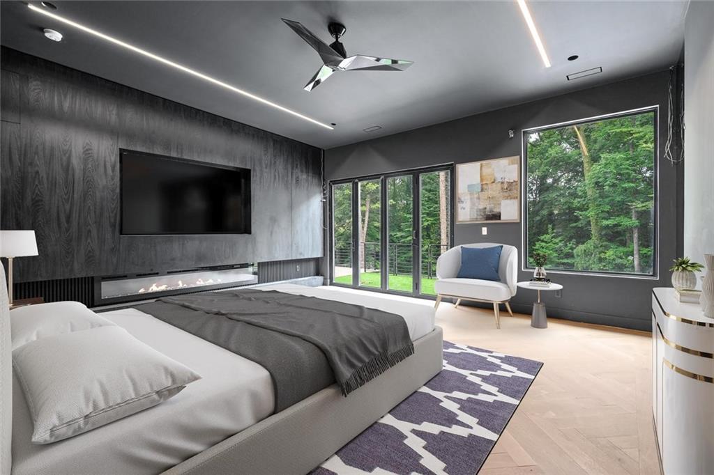 1355 Moores Mill Road Northwest Atlanta, GA 30327 - Photo 24 of 45 a bedroom with a large bed and a flat screen tv