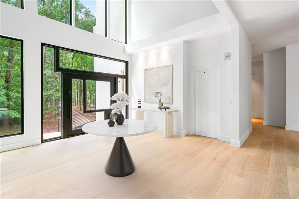 1355 Moores Mill Road Northwest Atlanta, GA 30327 - Photo 3 of 45 a view of a living room and floor to ceiling window