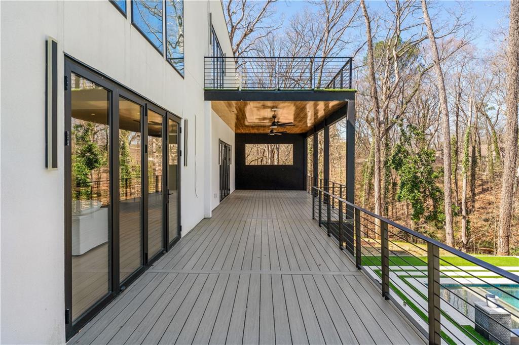 1355 Moores Mill Road Northwest Atlanta, GA 30327 - Photo 31 of 45 a view of a porch with wooden floor and stairs
