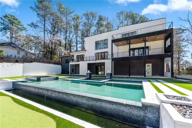 a view of a house with backyard stove and sitting area