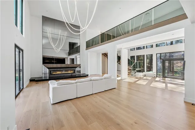 a kitchen with stainless steel appliances kitchen island wooden floors and refrigerator